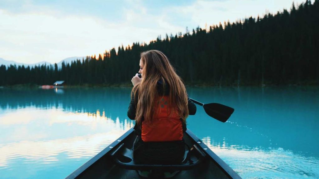 Kayak at dawn on misty lake
